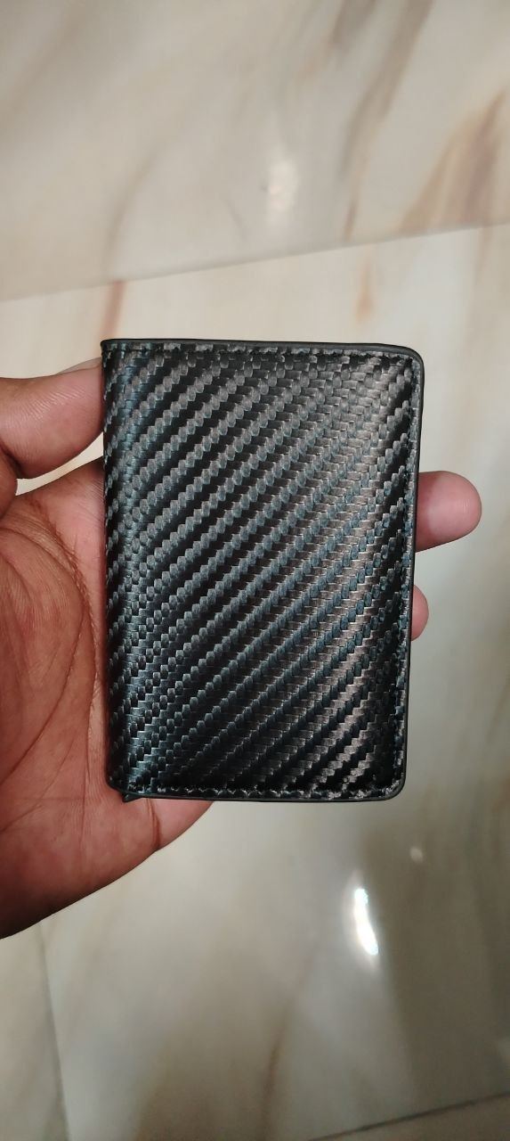 Actual wallet unit held in hand second angle